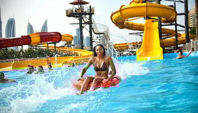 Families and friends enjoying thrilling rides and relaxing pools at Water Park Dubai Families and friends enjoying thrilling rides and relaxing pools at Water Park Dubai